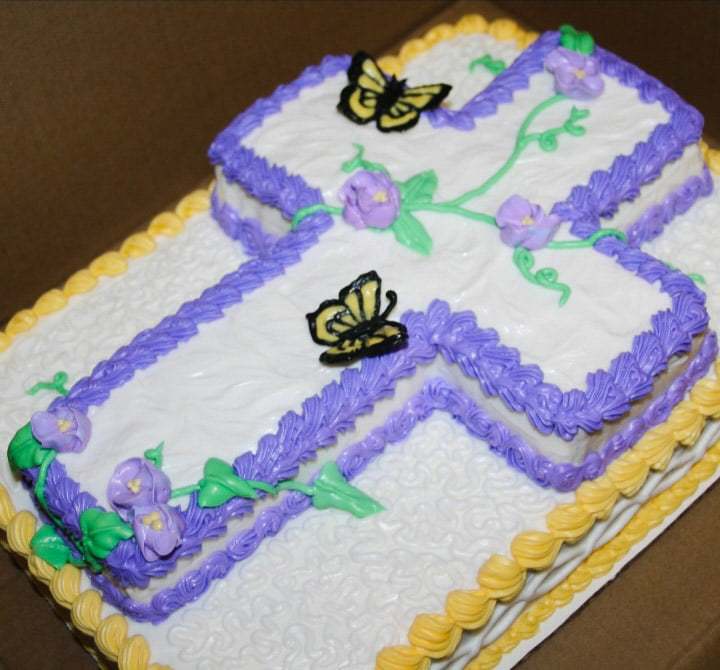 Bees and Berries Bakery and More custom two layer cake with the top layer of a cross with vines with purple flowers and butterflies